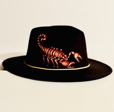 This black felt Fedora hat is a one of a kind, hand burned and hand painted original design. It would make a great hat for anyone who loves scorpions, spiders and other crawly things. Black Fedora Hat, Black Fedora, Hand Burn, Felt Fedora, Black Felt, Fedora Hat, Spiders, Scorpion, Original Design