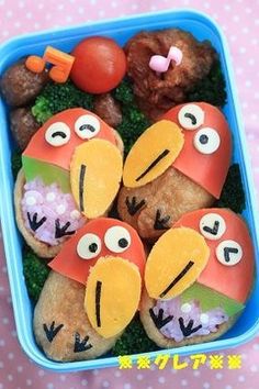 a plastic container filled with food shaped like angry birds