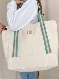 Our exquisite embroidered Custom Boat Tote Bags are the epitome of chic style and practical functionality. Crafted from premium-quality 100% organic cotton canvas, this tote radiates durability and offers ample space for all your needs. Whether it's school or office work, garment storage, grocery shopping, a day at the park or beach, events, trade shows, or your daily activities, this tote is your perfect companion. Make it truly special by personalising it with your own custom initials, creating a one-of-a-kind gift, especially for her. The vintage-inspired design evokes a sense of nostalgia, adding a unique charm to this versatile bag. The tasteful embroidery not only enhances its aesthetic appeal but also infuses an element of elegance, making it the ideal choice for a personalized and Rectangular Bags With Letter Embroidery For Everyday, Everyday Canvas Monogram Bags, Beige Embroidered Logo Bag For Summer, Customizable Green Bags For Daily Use, Trendy Bag With Embroidered Logo For Everyday, Green Bag With Embroidered Logo For Everyday Use, Trendy Everyday Bag With Embroidered Logo, Beige Canvas Bag With Embroidered Logo For Everyday Use, Everyday Canvas Bag With Embroidered Logo