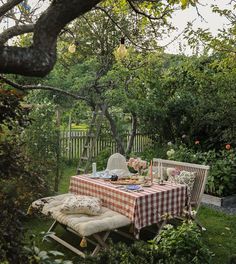 a picnic table in the middle of a garden