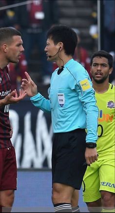 two soccer players are talking to each other