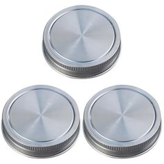 three metal knobs are shown on a white background