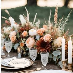 the table is set with candles, flowers and other items for an elegant wedding reception