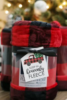 red and black plaid fabric wrapped around a glass jar with a label on it that says sleep in heavenly fleece