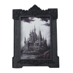 an ornate frame with a castle painted on it's front and back sides in black