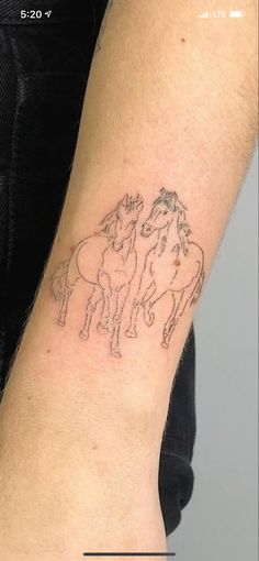 a person with a horse tattoo on their arm