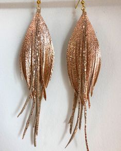 A beautiful pair of earrings, these are made using the finest quality soft metallic rose gold Italian leather. They are so light and soft, you will barely know that you are even wearing earrings. The color is the perfect accent to any outfit and is incredibly versatile. They measure approximately 4 inches in length. The earring hooks are gold plated. If you would like a different size, please just leave me a note at checkout. Gold Feather Earrings For Party, Adjustable Gold Feather Earrings, Gold Feather Earrings, Leather Feathers, Leather Feather Earrings, Earrings Rose Gold, Gold Feathers, Greenville Sc, Pretty Earrings