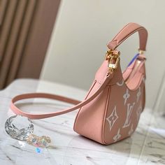 Features: M46301 The Bagatelle mini hobo handbag is fashioned from lush grained Monogram Empreinte leather. The oversized, embossed pattern in a pink-and-cream colorway perfectly fits the bag’s curves. The Bagatelle can be carried as a baguette-hobo, on the elbow, or cross-body with its detachable, adjustable strap. 9.4 x 7.1 x 2.8 inches (length x Height x Width) 24 x 18 x 7 cm Trianon Pink / Cream Embossed grained cowhide leather Grained cowhide-leather trim Microfiber lining Gold-color hardware Zip closure Inside flat pocket Strap:Removable, adjustable Strap drop: 18.9 inches Strap drop max: 21.3 inches Handle:Single, removable Embossed Pattern, Hobo Handbag, Crystal Shoes, Christian Louboutin Women, Hermes Bags, Hobo Handbags, Prada Bag, New Bag, Leather Trim