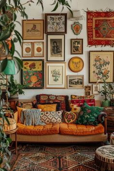 a living room filled with lots of pictures on the wall and couches covered in pillows