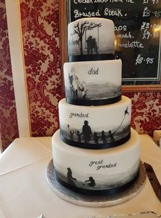 a three tiered cake sitting on top of a table next to a chalkboard