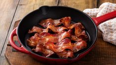 cooked bacon in a red cast iron skillet