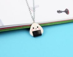 Hi CutiePie,  I'm Cute onigiri necklace. I'm pendant created from polymer clay without using any molds and completely handmade. I can be a funny gift for people of all ages. I'll always cheers You up and will bring a smile on your face.My dimensions are:Length 1" ( or 2.5 cm. )Width 1" ( or 2.5 cm. )Chain length: 18" ( 45 cm. )❀I come in a pretty box but please note in the event that several items are purchased all of us will ship in one box.❀ Because I'm made by hand, I may differ slightly than Cute Onigiri, Kawaii Onigiri, Jewelry Japanese, Clay Necklaces, Food Necklace, Ball Jewelry, Mini Clay, Rice Ball, Food Jewelry