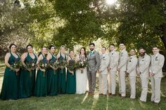 a group of people standing next to each other on top of a lush green field