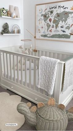 a baby's room with a crib, rugs and pictures on the wall