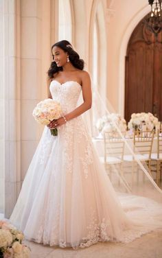 a woman in a wedding dress holding a bouquet