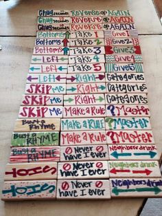 a wooden table topped with lots of different colored writing on top of wood planks