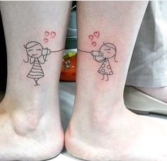 two people with tattoos on their legs holding hands and hearts flying in the air above them