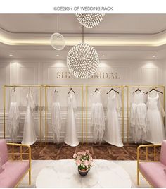 a room filled with lots of white dresses on hangers next to pink couches