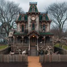 an old wooden house with a clock on the front