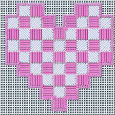 a cross stitch heart with pink and white squares