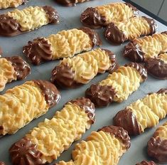 chocolate covered cookies are lined up on a baking sheet