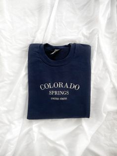 Take a little vacation to Colorado Springs with this crewneck sweatshirt. This sweatshirt features long sleeves, a crew neckline, and beautiful front embroidery. The Unisex Sizing makes the sweatshirt run slightly larger than your average sweatshirt for women. Most men find their normal size to be more snug. If you want a slightly looser fit, size up one size. PLEASE BE SURE TO INPUT YOUR CORRECT SIZE/COLOR + SHIPPING ADDRESS. We will not be responsible if it is incorrect! SHIPS OUT IN 1-2 WEEKS Embroidery Clothing, Cute Crewneck, Sweatshirt Aesthetic, Crewneck Sweatshirt Women, Crewneck Design, Embroidered Crewneck, Sweatshirt Outfit, Cute Sweatshirts, Embroidered Sweatshirt