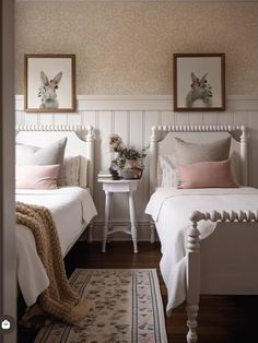 two white beds in a bedroom with pink and white decor on the headboard, nightstands and rug