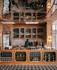 a kitchen with lots of wooden cabinets and counter top space in front of a window