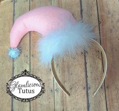 Hello and welcome to my store! This listing is for one Elf hat headband!  The headband is made of Pink felt and attached to a White headband The headband has white feathers along the bottom and a white sparkly ball on the end.  This headband is a one size fits most! Perfect for toddlers to adults!  Perfect for Holiday get together, pageants, and school musicals!  ASK ABOUT BULK PRICES!  Want to rush your order? Use this listing!  https://www.etsy.com/listing/169410291/rush-order-fee?ref=shop_hom Pink Ears Headband Gift, Whimsical Pink Costume Headband, Elf Headband, Adjustable Pink Winter Headband, Pink Santa Hat, Adjustable Pink Headband, Hat Headband, Pink Santa, Pink Felt