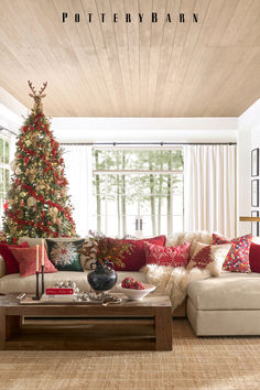 a living room filled with furniture and a christmas tree