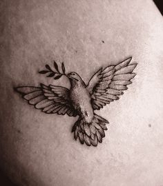 a black and white photo of a bird tattoo