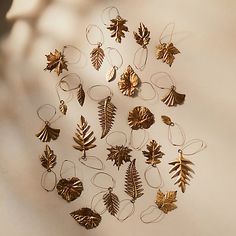 a group of gold leaf ornaments on a white surface