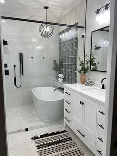 a bath room with a tub a sink and a rug on the floor in front of it