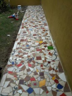 a walkway made out of different colored tiles