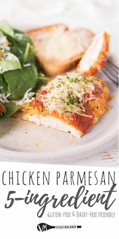 a white plate topped with chicken parmesan and spinach