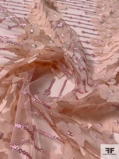 Beds of pink flowers in perfect rows are pretty as can be on this blush and pink fine netting with 3D floral chiffon appliqués and sequins detailing designer fashion fabric. SKU: 12322 Content: Polyester Color: Blush / Pink Width: 50 inches This fabric is a last cut and no longer in production. Once sold out, we are unable to get more. Spring Pink Tulle Fabric, Pink Tulle Fabric For Summer Parties, Elegant Pink Sequin Fabric With Floral Embroidery, Pink Sequin Tulle Fabric For Party, Pink Tulle Sequin Fabric For Party, Pink Organza Tulle Fabric For Spring, Spring Party Tulle Fabric Made Of Net, Pink Tulle Fabric For Summer Wedding, Elegant Pink Fabric For Party