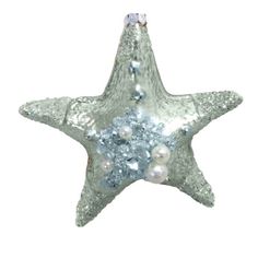 a silver star ornament with pearls on it