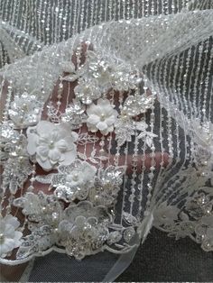 "This stunning Lace Fabric design piece has soft hand feel, It's perfect for weddings, bridal parties, and any events. Shop our large inventory of bridal fabrics. ☆PRODUCT DESCRIPTION : This gorgeous fabric is made on a sheer base with a beautiful flower embroidery and delicate beaded throughout. The fabric width is approximately 51\" (130cm) Wide. Color: off white or beige as in picture Material: Rayon, Polyester, Pearls, Sequins ☆ PURCHASING INFORMATION: This fabric is sold by the yard and eac Elegant Floral Applique Wedding Gown, Wedding Dress With 3d Embroidery In Organza, Wedding Tulle Dress With 3d Flowers, Wedding Dresses With 3d Flowers And Tulle, Wedding Dress With 3d Flowers In Tulle, Wedding Gown With Floral Embroidery And Tulle Material, Wedding Organza Gown With Floral Embroidery, Wedding Gown With Floral Embroidery In Organza, Organza Wedding Gown With Floral Embroidery