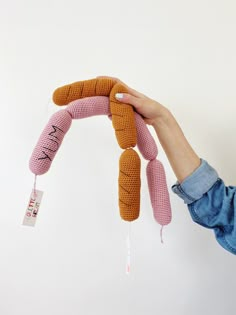 a person holding a stuffed animal in the shape of a banana with writing on it