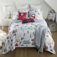 a bed with christmas themed comforters and pillows