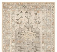 an antique rug with various colors and patterns on the carpet, including beiges, browns,