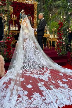 the bride is getting ready to walk down the aisle in her wedding dress and veil