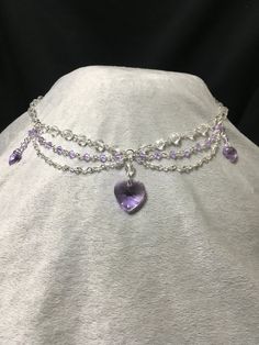 Elegant and dainty necklace made using violet Swarovski bicone beads and featuring three violet Swarovski heart pendants. Necklace is 19.5 inches long, with a lobster clasp closure. Crystal Heart Cut Jewelry With Heart Charm, Elegant Crystal Heart Pendant Necklace, Elegant Heart-shaped Crystal Necklace For Valentine's Day, Crystal Heart Pendant Necklace For Wedding, Elegant Heart Necklace With Rhinestones For Parties, Elegant Heart Pendant Crystal Necklace For Valentine's Day, Wedding Crystal Heart Pendant Necklace, Elegant Valentine's Day Crystal Necklace With Heart Pendant, Crystal Heart Pendant Necklace For Party