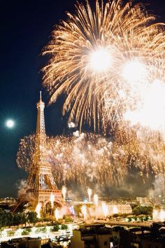 the eiffel tower is lit up with fireworks