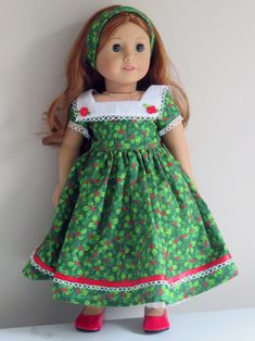 a doll wearing a green dress and red shoes