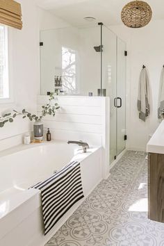 a bathroom with a bathtub, sink and shower in it's own area