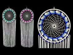 three white and blue dream catchers hanging from the side, one with feathers on it