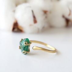 Dark green and gold create an emerald ring that sings with elegance and stands for bravery. The adjustable ring easily fits various ring sizes. The 14k gold filled metal setting creates a long-lasting and hypoallergenic ring. Each handmade pair uses a three step adhering process to guarantee durability and quality, Hypoallergenic material guarantees no reaction when you wear them. As no raw stone is the same, each emerald ring has a slightly different shape and size guaranteeing uniqueness and i No Reaction, Gold Filled Ring, Ring Sizes, Raw Stone, Emerald Ring, Adjustable Ring, Adjustable Rings, Green And Gold, Gold Filled