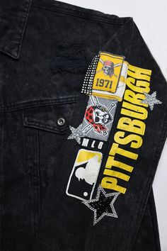 a black jean jacket with patches on the back and side pockets that say, pittsburgh