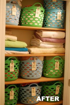 the closet is filled with lots of different colored laundry baskets and folded towels in it